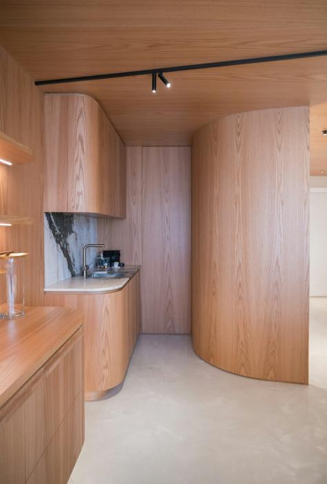 Warm wood kitchen with curved cabinetry